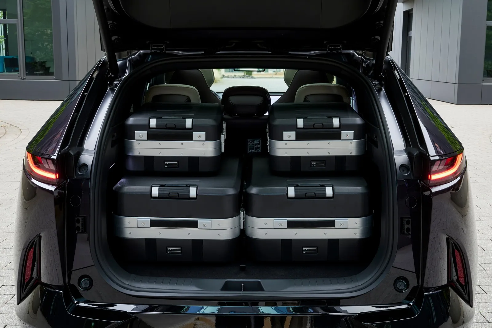 Vier Koffer liegen im Kofferraum vom Mazda CX 6e.