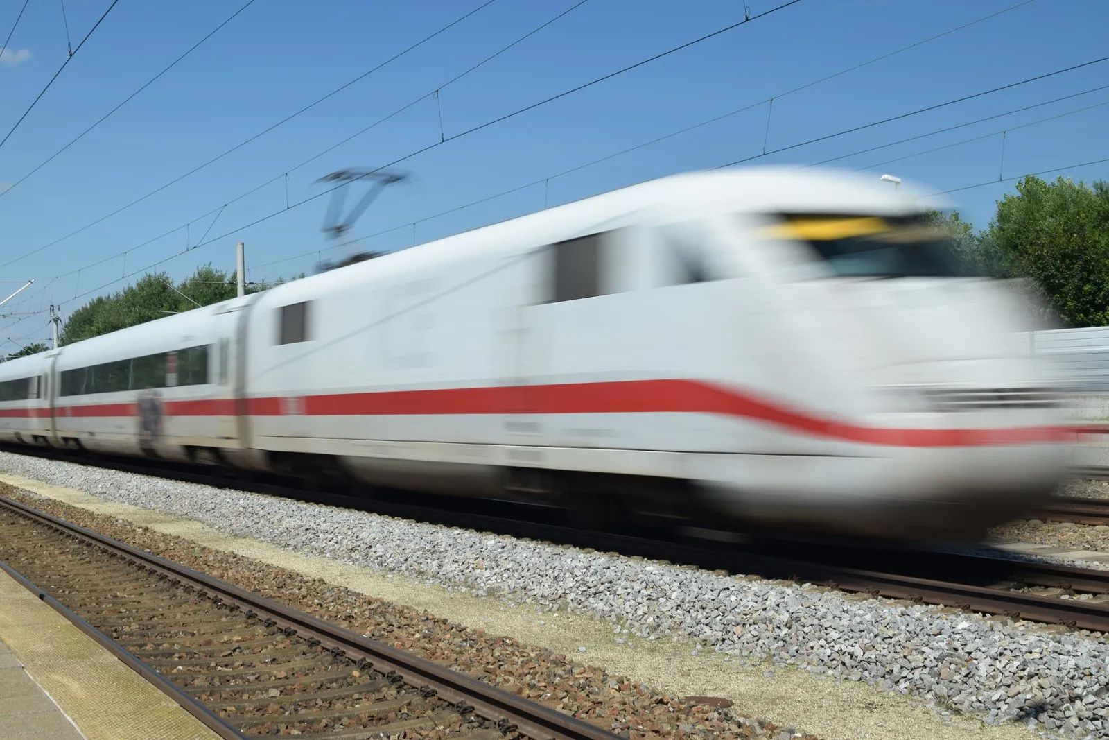 Ein ICE der Deutschen Bahn fährt schnell los.